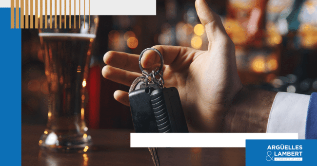 Close-up of car keys and alcoholic drink representing a DWI charge in Texas