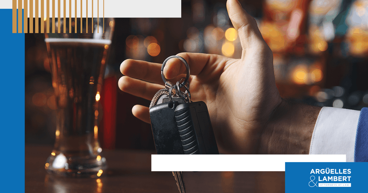 Close-up of car keys and alcoholic drink representing a DWI charge in Texas