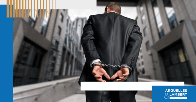 white-collar-crimes-texas-charges-penalties Business professional in handcuffs representing white collar crime charges and criminal penalties in Texas